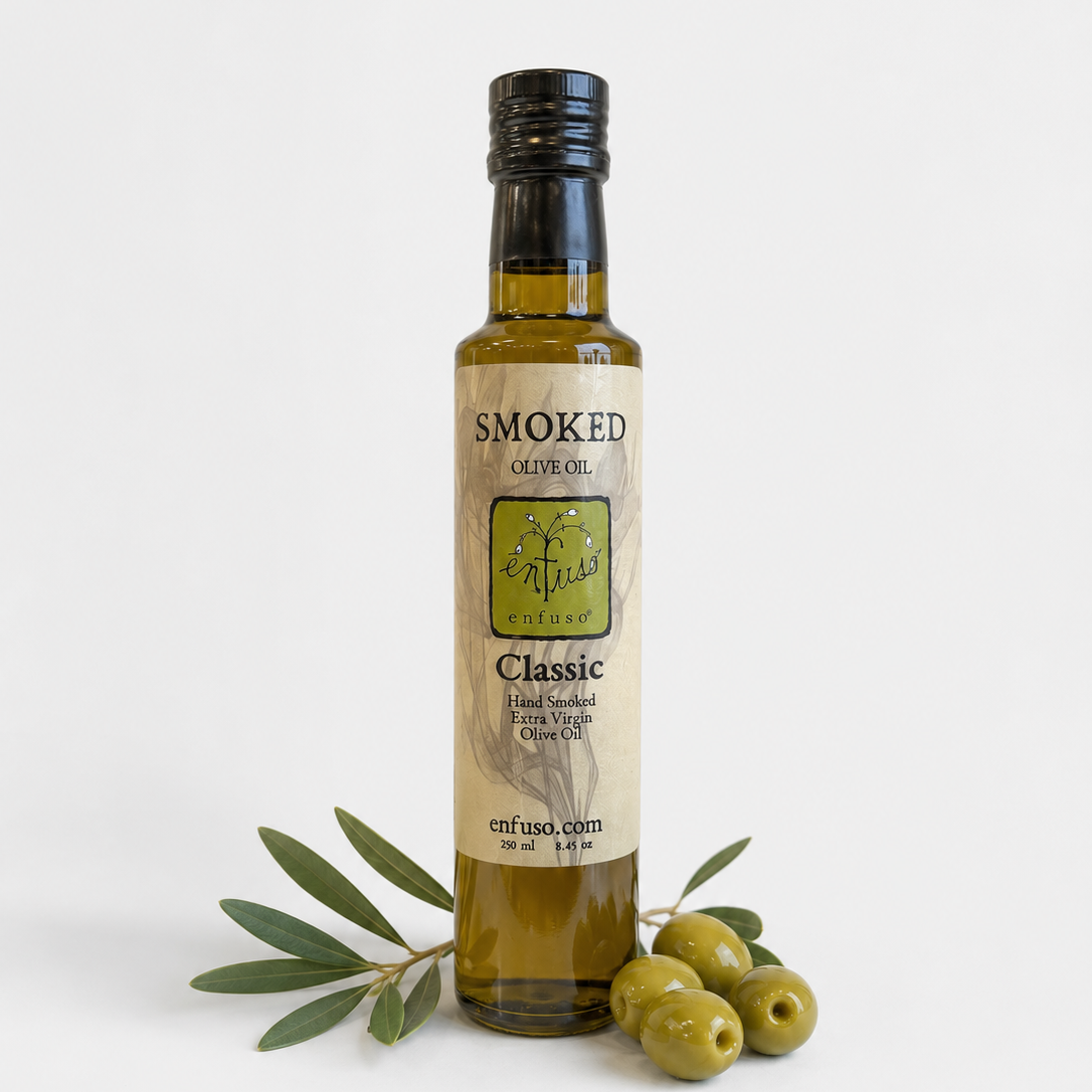 Bottle of smoked olive oil with olives on a white background